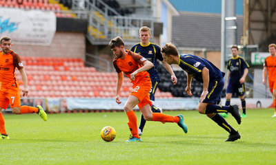 Sam Stanton drives away from the Alloa defence.