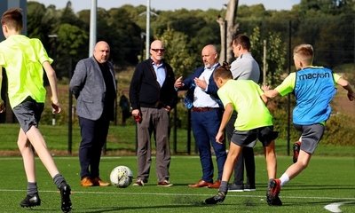 (from left to right) Sporting Director Tony Asghar, Chairman Mark Ogren, Baldragon Academy Headmaster Hugh McAninch, and Andy Goldie watch training at Baldragon